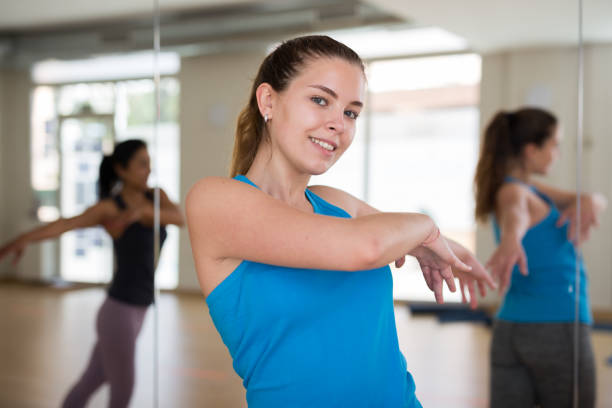 istock Cheerful girl practicing vigorous jive in group dance class 1312669159