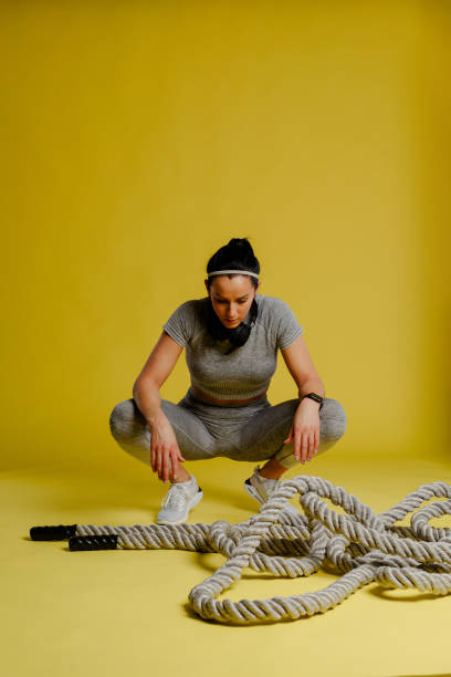 istock Young fit woman is taking a break between two series exercises with rope. 1312670221