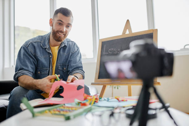 istock Man recording educational video for his vlog on camera 1312671601