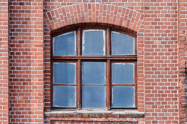 istock One arched glass window on old red brick wall 1312671692