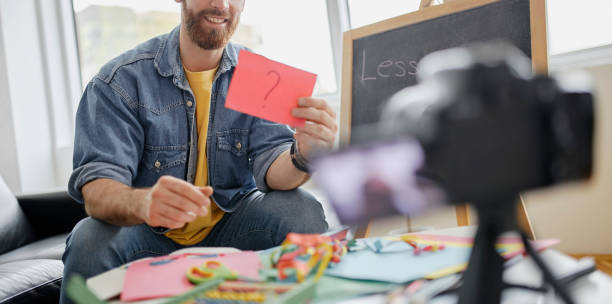 istock Man recording educational video for his vlog on camera 1312671833
