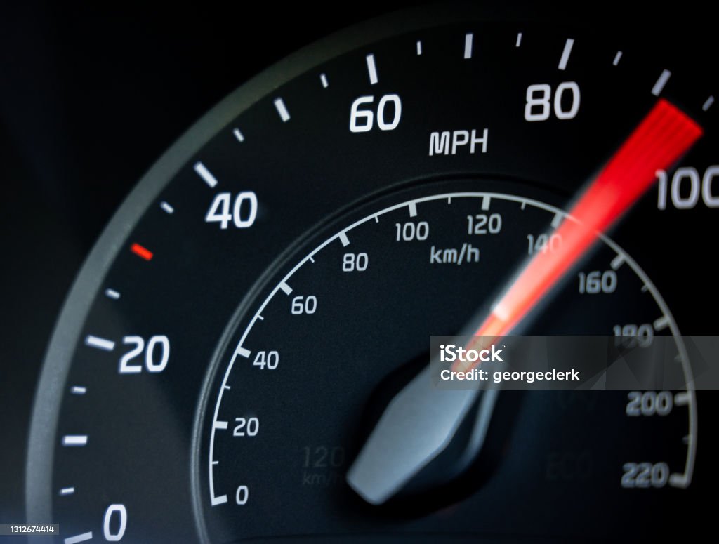 Accelerating to 100mph Close-up showing the needle on a car's speedometer moving towards 100 miles per hour. Speedometer Stock Photo