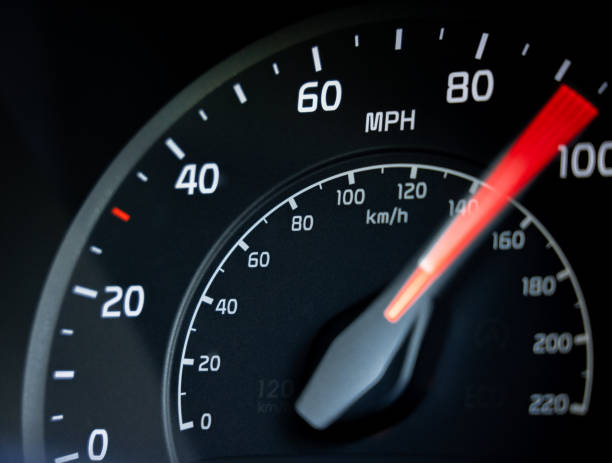 Accelerating to 100mph Close-up showing the needle on a car's speedometer moving towards 100 miles per hour. gauge photos stock pictures, royalty-free photos & images