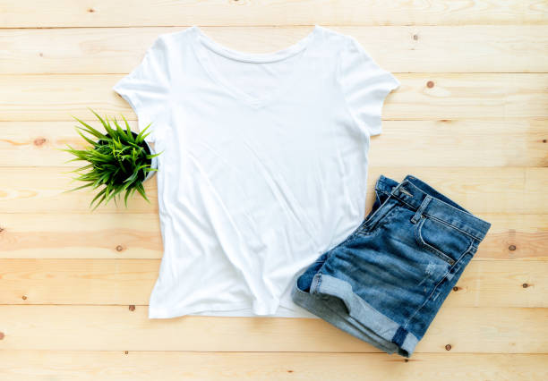 istock White tshirt mockup and short jeans on brown wooden background. Template, flat lay, template 1312675510