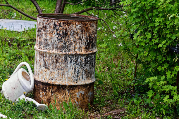 istock an old iron barrel stands among the trees 1312677801