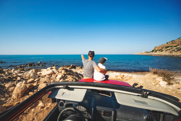 istock Road trip. Father and son travelling together by ca 1312678131