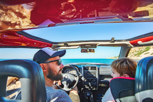 istock Road trip. Father and son travelling together by ca 1312678783