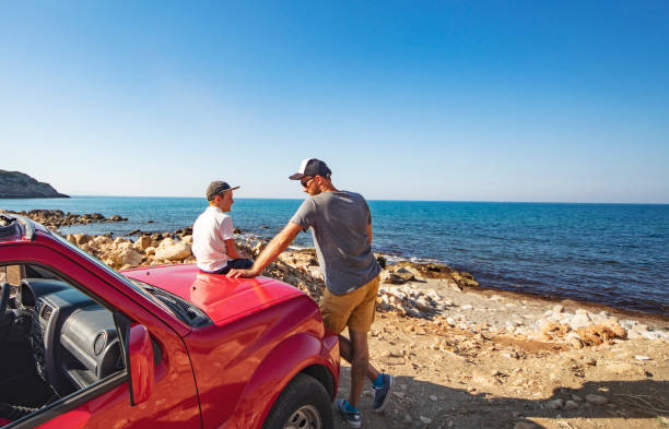 Road trip. Father and son travelling together by ca