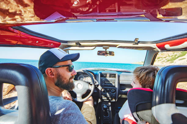 istock Road trip. Father and son travelling together by ca 1312678917