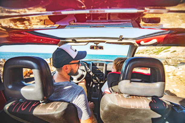 Road trip. Father and son travelling together by ca