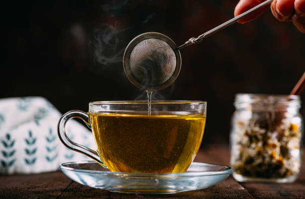 chamomile tea on rustic wooden background - chamomile imagens e fotografias de stock