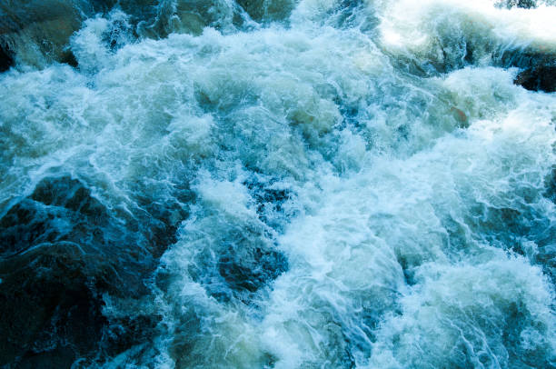 istock raging waterfall water is billowing against rocks 1312681722
