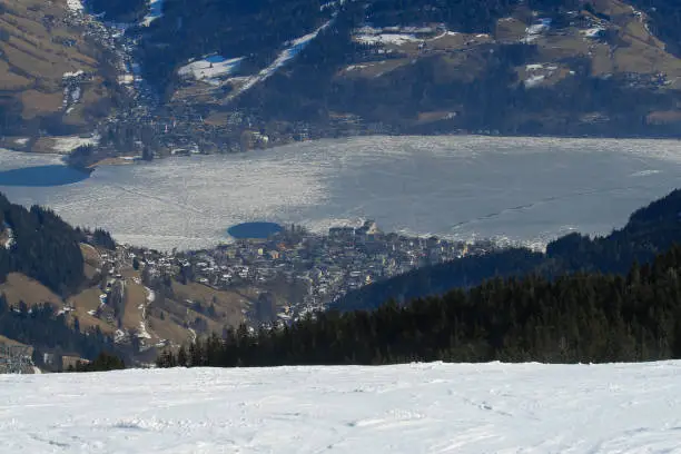 Top view of the snowy town and lake Zell am See in Austria.