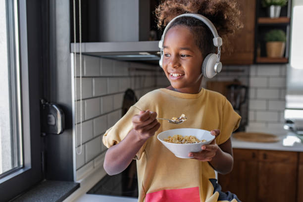 istock Young girl eating breakfast in the kitchen 1312688986