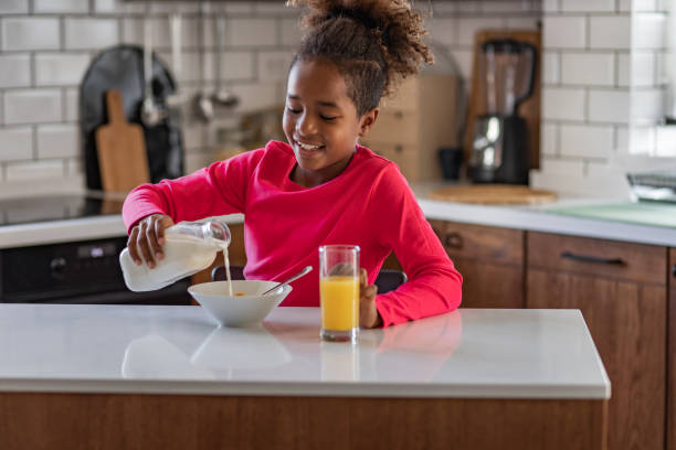 istock Young girl eating breakfast in the kitchen 1312688988