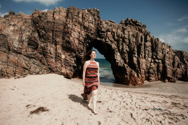 istock Woman walking in the sand 1312689336