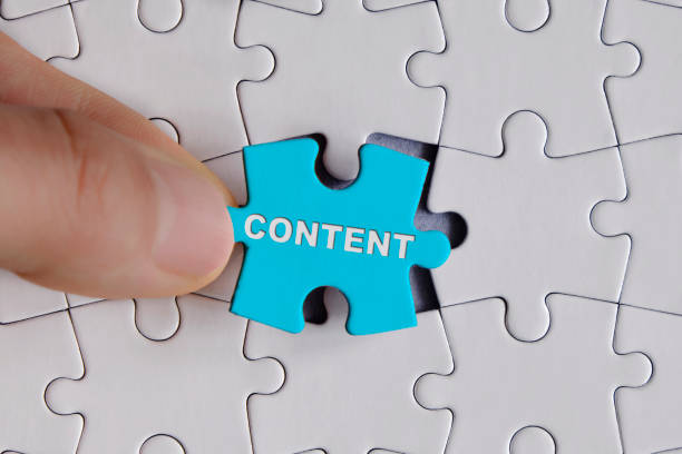 Placing last piece "content" written on the blue puzzle piece stock photo