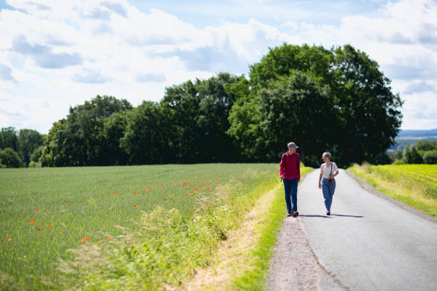 istock Seniors hiking on rural road 1312691614