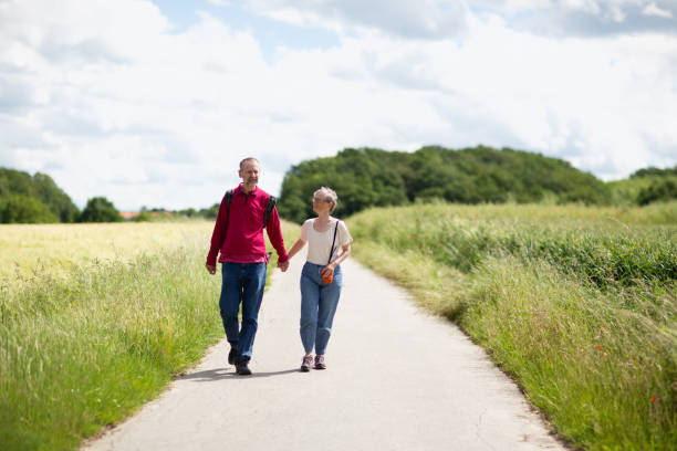 istock Seniors hiking on rural road 1312691624