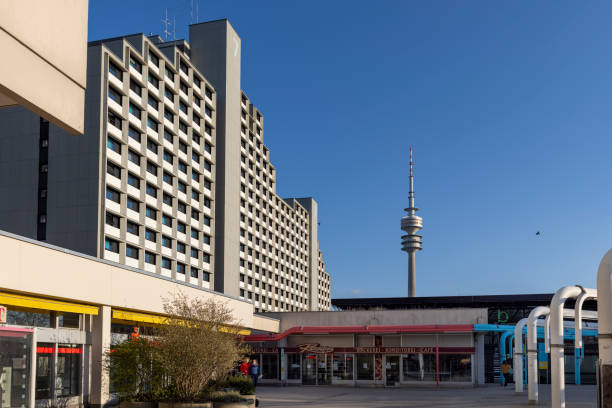 Tower with satellite antennas on a high-rise building against the background of the blue sky.