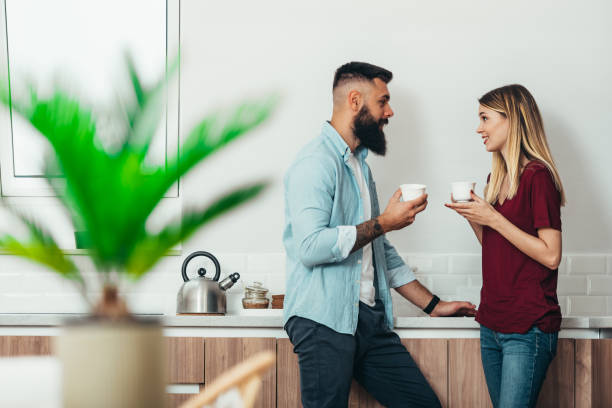 istock Couple drinking coffee in the kitchen at home 1312694458