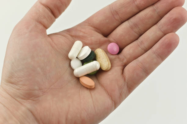 istock Medical pills in the man's hand 1312695929