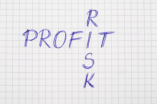 Photography of Profit risk concept  ,handwriting with pen on note pad