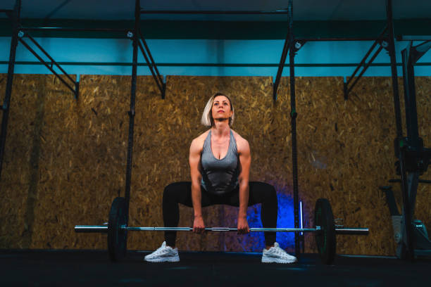 istock Sportswoman lifting barbell 1312700722