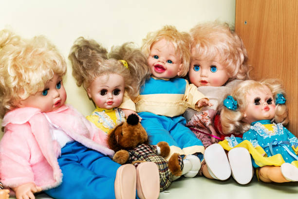 istock Group of plastic retro dools seated on wooden table in kindergarten 1312702580