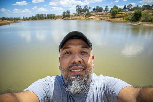 Man taking selfie in a lake