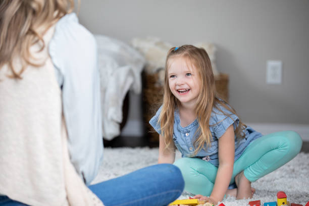 istock Beautiful child cmiles and laughs while playing with mom 1312706366