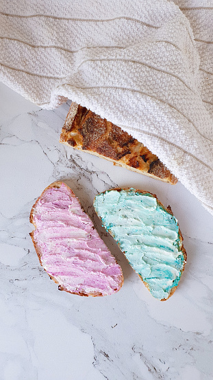 Two pieces of bread with pink and cyan cream cheese and a bread loaf in Moscow, Moscow, Russia