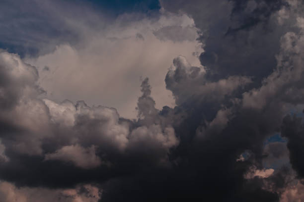 istock dramatic sky with cumulus clouds shaded with gray, floating under a blue sky covered by stratus clouds 1312711534