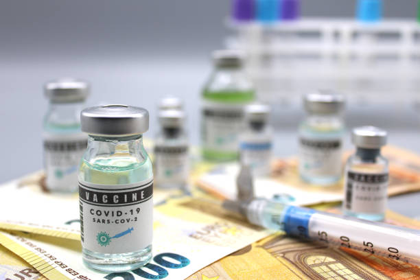 istock Vaccine vials covid and on euro banknotes 1312711990