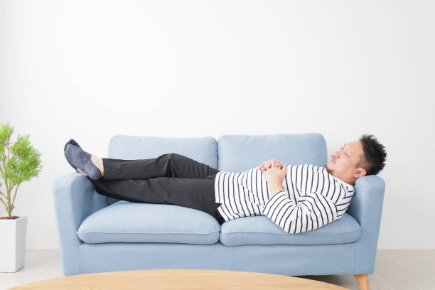 istock Middle-aged man taking a nap at home 1312717265
