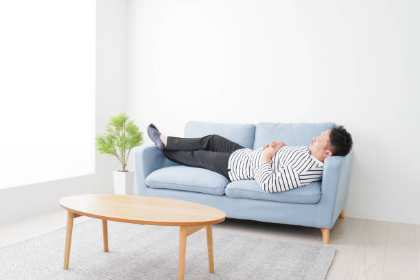 istock Middle-aged man taking a nap at home 1312717274