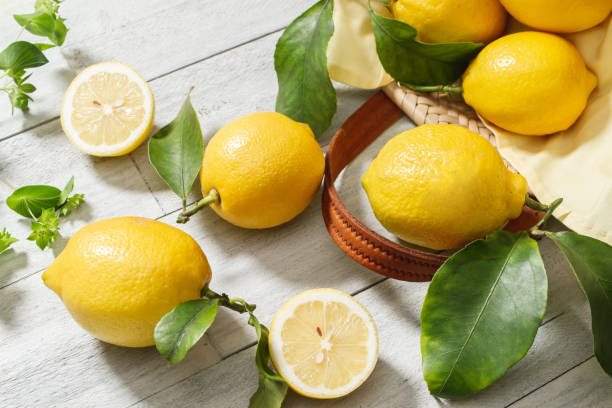 istock Lemon on a wooden white background 1312718841