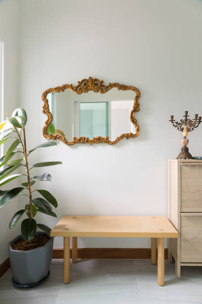 istock Modern hallway interior with mirror on wall and wood chair. 1312724806