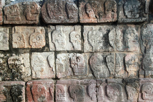 istock Wall of Carved Stone Skulls at Chichen Itza Archeological Ruins 1312725555