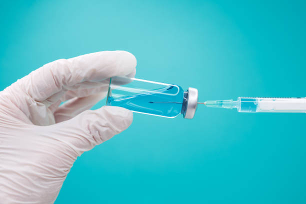 istock Immunity against diseases. Medical syringe with blue liquid. 1312728749