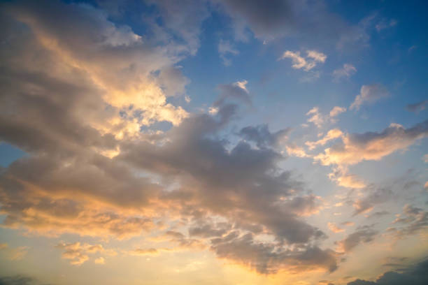 cloudy deep golden blue sky in evening before sunset with noise and grain