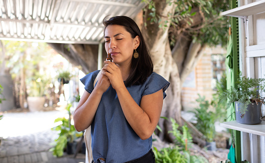 Young woman smelling the scent of an essential oil in an outdoor store