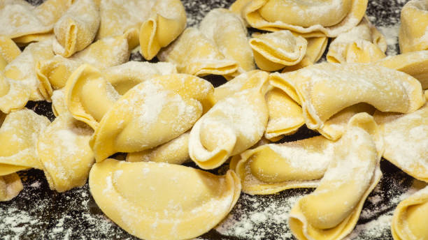 A kind of ravioli, casoncelli, home made traditional food of the Bergamo area, Italy. Delicious Italian food. Black background stock photo