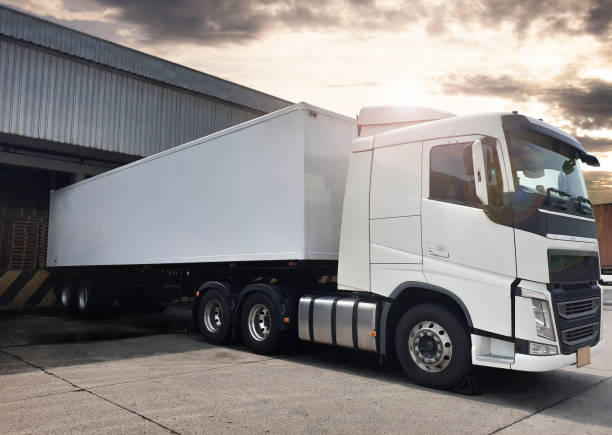 istock Semi Truck Parked Loading at Dock Warehouse. Cargo Shipment. Industry Freight Truck Transportation. Shipping Warehouse Logistics. 1312741301