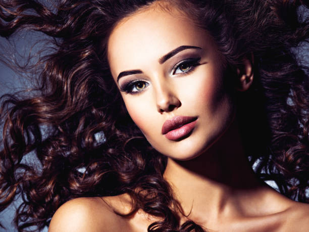 istock Woman with long bown curly hair 1312744152