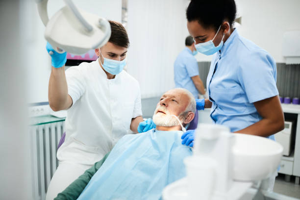 istock Senior man having dental exam during appointment at dentist's office. 1312745897