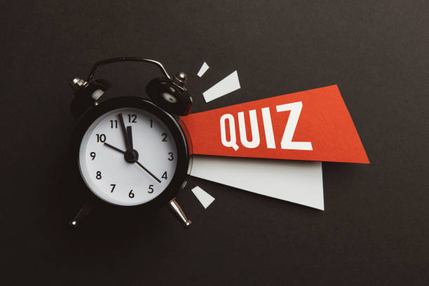 Quiz Alarm clock and color papers on the black background. trivia night stock pictures, royalty-free photos & images