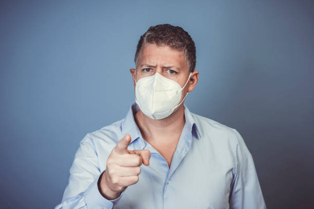 istock Middle-aged man with ffp2 protective mask and blue shirt 1312747221