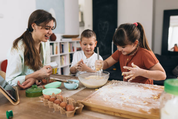 istock mother baking with kids at home 1312748296