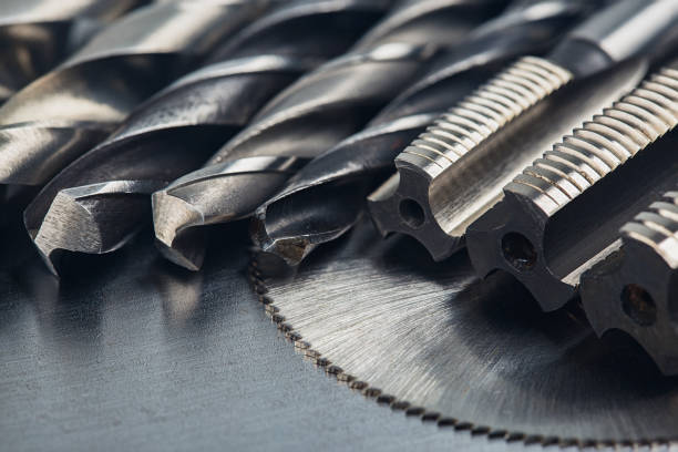 istock set of different drill bits,thread tap and mill cutters with caliper ruler on steel plate background. Locksmithing deal. 1312749153